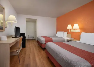 a hotel room with two beds and a desk at Motel 6-Buena Park, CA - Knotts Berry Farm - Disneyland in Buena Park