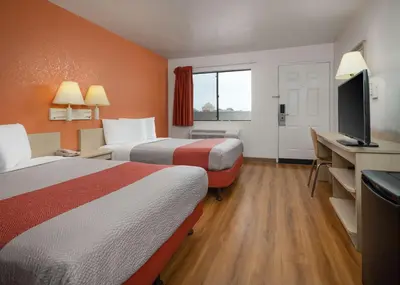 a hotel room with two beds and a flat screen tv at Motel 6-Buena Park, CA - Knotts Berry Farm - Disneyland in Buena Park