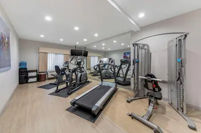 a gym with several tread machines in a room at Best Western Plus Executive Inn Rowland Height City of Industry in Rowland Heights