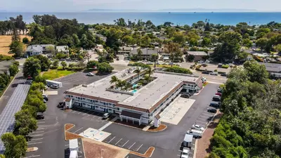 an aerial view of a building with a parking lot at Motel 6-Carpinteria, CA - Santa Barbara - South in Carpinteria