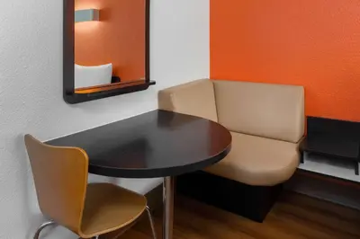 a small table and a chair in a room at Motel 6-Carpinteria, CA - Santa Barbara - South in Carpinteria