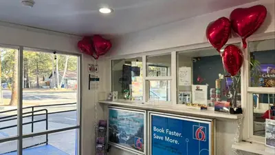 a store with red balloons hanging from the ceiling at Motel 6-Big Bear Lake, CA in Big Bear Lake