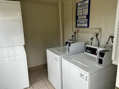 a kitchen with two microwaves on a counter next to a refrigerator at Valley Inn in Mission Hills