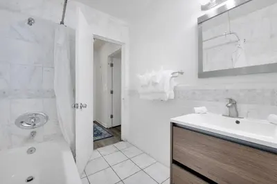 a white bathroom with a sink and a shower at Magic Castle Hotel in Los Angeles