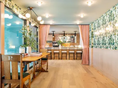 a dining room with a table and a bar at Palihotel Hollywood near Universal Studios in Los Angeles