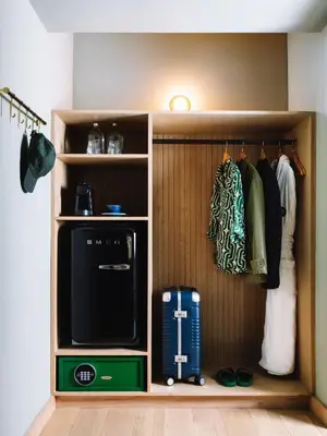 a walk in closet with a tv and clothes at Palihotel Hollywood near Universal Studios in Los Angeles
