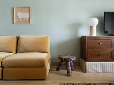 a living room with a couch and a chair and a table at Palihotel Hollywood near Universal Studios in Los Angeles