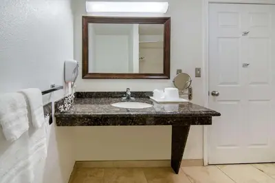 a bathroom with a sink and a mirror at Rodeway Inn Adelanto US 395 in Adelanto