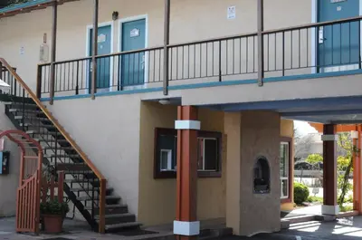 a building with stairs and a stair case at Sandyland Reef Inn in Carpinteria