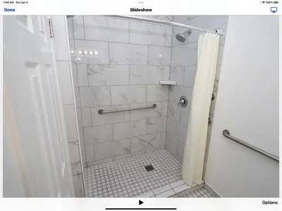 a bathroom with a shower with a glass door at Ocean Lodge Santa Monica Beach Hotel in Los Angeles