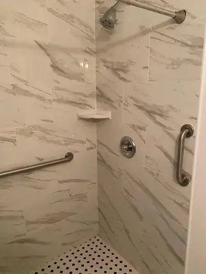 a bathroom with a shower with a glass door at Ocean Lodge Santa Monica Beach Hotel in Los Angeles