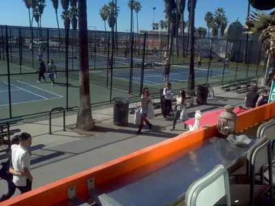 a group of people playing tennis at a tennis court at Ocean Front Vortex Female Hostel private rooms Free bikes in Los Angeles