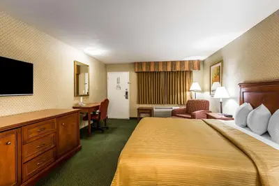 a hotel room with a bed and a desk at Quality Inn Near China Lake Naval Station in Ridgecrest