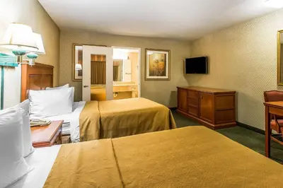 a hotel room with two beds and a television at Quality Inn Near China Lake Naval Station in Ridgecrest
