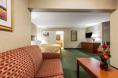 a hotel room with a bed and a couch at Quality Inn Near China Lake Naval Station in Ridgecrest