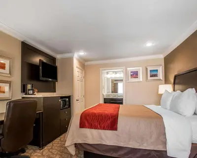 a hotel room with a bed and a desk at Quality Inn Downey in Downey