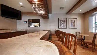 a bar with chairs and a large wooden table at Best Western San Dimas Hotel & Suites in San Dimas