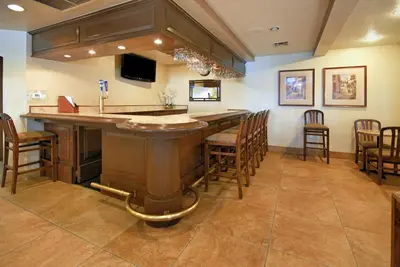 a large bar in a room with chairs at Best Western San Dimas Hotel & Suites in San Dimas