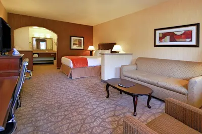 a hotel room with a bed and a couch and a television at Best Western San Dimas Hotel & Suites in San Dimas