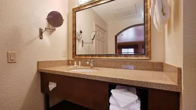 a bathroom with a sink and a mirror at Best Western San Dimas Hotel & Suites in San Dimas