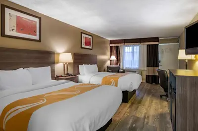 a hotel room with two beds and a television at Quality Inn Barstow Route 66 in Barstow