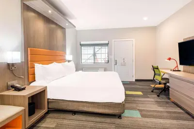 a hotel room with a bed and a tv at Rodeway Inn near Melrose Ave in Los Angeles