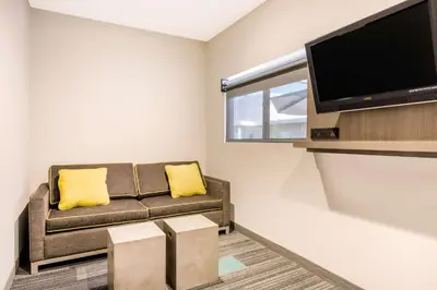 a living room with a couch and a flat screen tv at Rodeway Inn near Melrose Ave in Los Angeles
