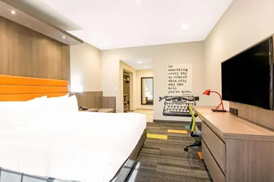 a hotel room with a bed and a flat screen tv at Rodeway Inn near Melrose Ave in Los Angeles