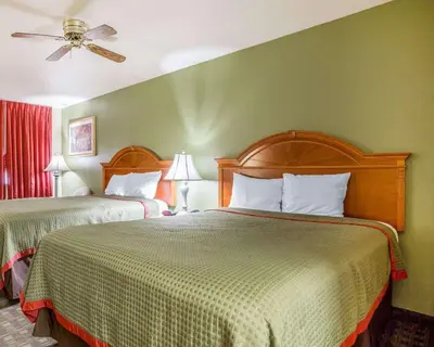 a hotel room with two beds and a ceiling fan at Rodeway Inn Delano in Delano