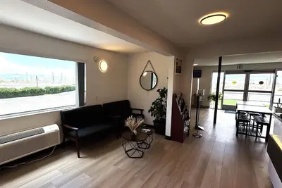 a living room with a couch and a large window at Days Inn by Wyndham Ridgecrest near China Lake Naval Station in Ridgecrest