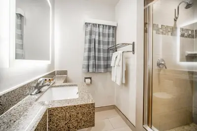 a bathroom with a sink and a shower at Inn at 50 Long Beach Convention Center in Long Beach