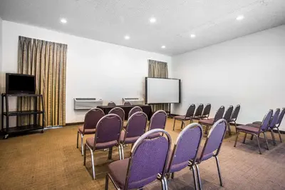 a conference room with purple chairs and a screen at Baymont by Wyndham Ontario in Ontario