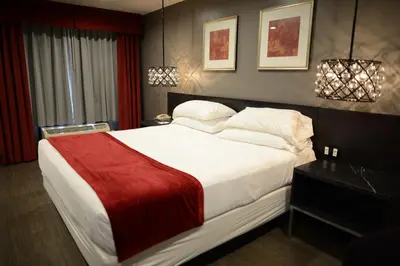a bedroom with a large white bed with a red blanket at Hotel Le Reve Pasadena in Pasadena