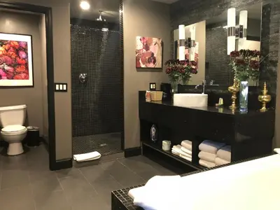 a bathroom with a sink and a shower and a toilet at Hotel Le Reve Pasadena in Pasadena