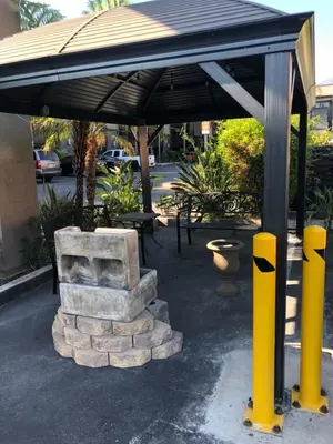 a pavilion with a bench and an umbrella at Hotel Le Reve Pasadena in Pasadena