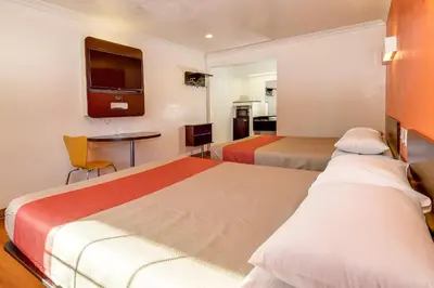 a hotel room with two beds and a television at Motel 6 Garden Grove in Anaheim