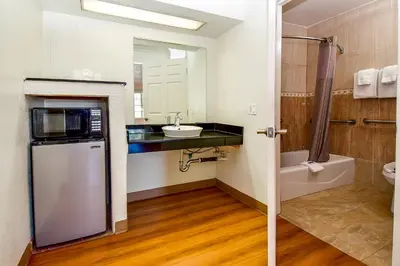 a small bathroom with a sink and a microwave at Motel 6 Garden Grove in Anaheim