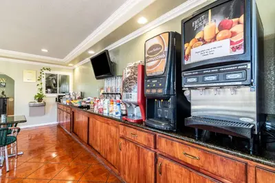 a bar with a drink dispenser and a soda machine at Rodeway Inn Barstow Route 66 in Barstow