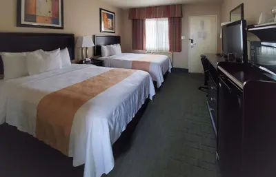 a hotel room with two beds and a television at Quality Inn & Suites Anaheim at the Park in Anaheim