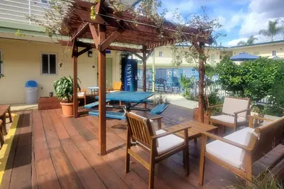 a patio with a table and chairs and a wooden deck at Quality Inn & Suites Anaheim at the Park in Anaheim