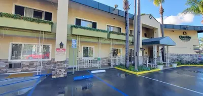 a hotel with a parking lot in front of it at Quality Inn & Suites Anaheim at the Park in Anaheim