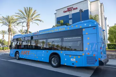 a blue bus parked in front of a building at Hilton Garden Inn Anaheim/Garden Grove in Anaheim