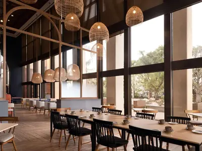 a restaurant with tables and chairs and large windows at Hotel Fera Anaheim, a DoubleTree by Hilton Hotel in Anaheim