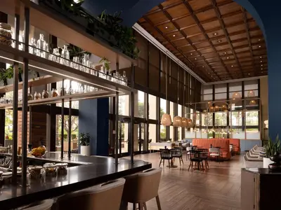 a restaurant with a bar with chairs and tables at Hotel Fera Anaheim, a DoubleTree by Hilton Hotel in Anaheim