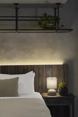 a bedroom with a bed and a lamp on a table at 1 Hotel West Hollywood in Los Angeles