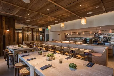 a restaurant with tables and chairs and a bar at 1 Hotel West Hollywood in Los Angeles