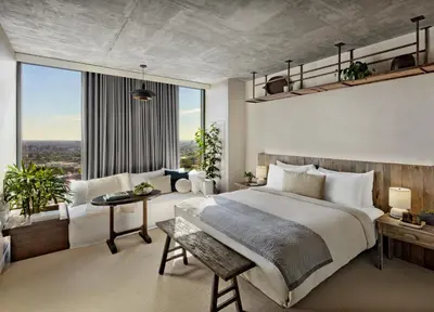 a bedroom with a large bed and a large window at 1 Hotel West Hollywood in Los Angeles