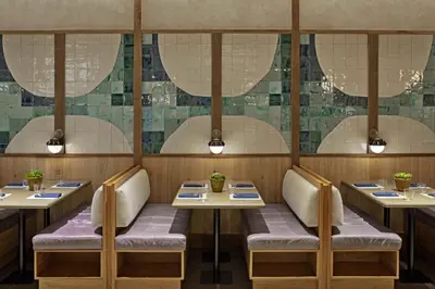 a dining room with tables and chairs with lights at 1 Hotel West Hollywood in Los Angeles