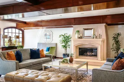 a living room with couches and a fireplace at Ayres Suites Diamond Bar in Diamond Bar