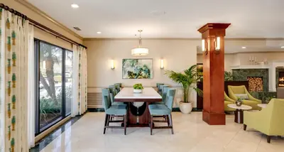 a dining room with a table and chairs at Ayres Hotel Corona - Riverside in Corona
